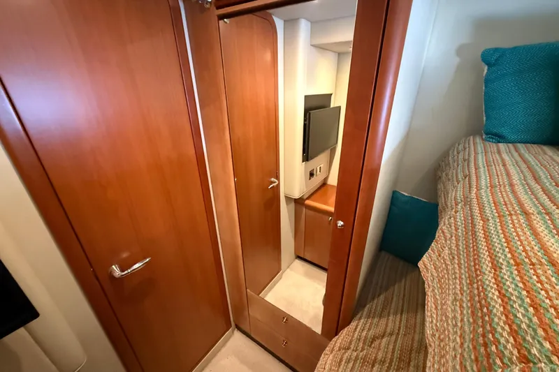Seaya II Yacht Photos Pics Interior of 2008 Sunseeker Manhattan 50 yacht with wood paneling and cozy bedding.