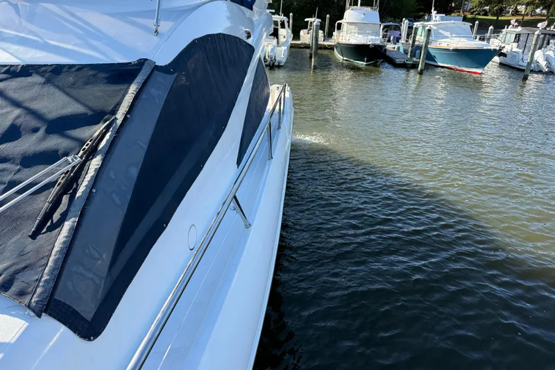 Seaya II Yacht Photos Pics 2008 Sunseeker Manhattan 50 yacht docked at marina, side view with water reflections.