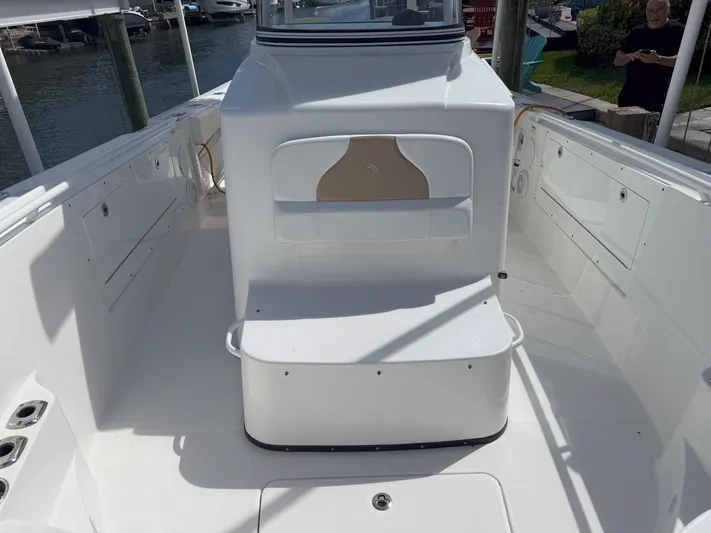 Dan's Seachelle Yacht Photos Pics 2019 Edgewater 320CC boat interior, featuring spacious deck and seating area.