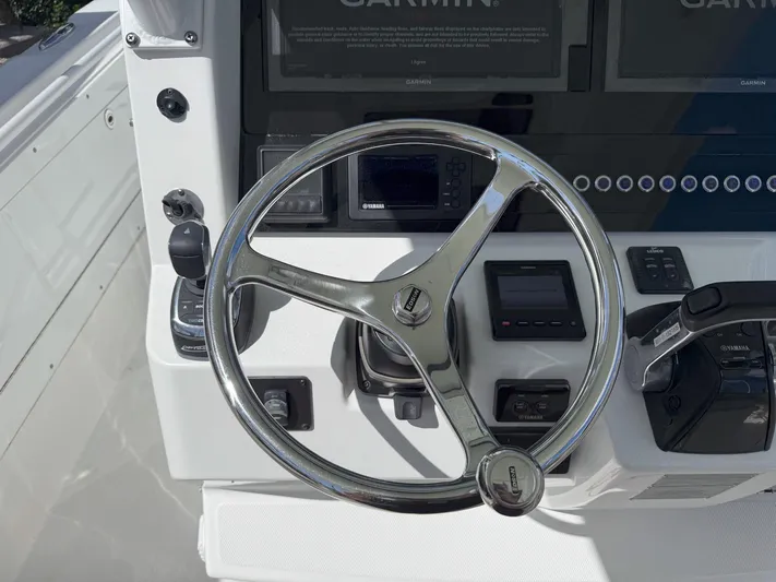 Dan's Seachelle Yacht Photos Pics Steering wheel and controls of 2019 Edgewater 320CC boat cockpit.