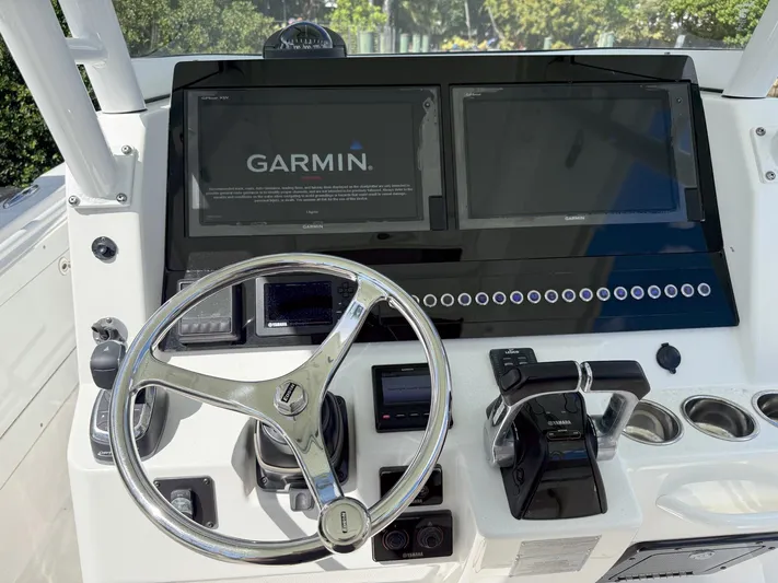 Dan's Seachelle Yacht Photos Pics Edgewater 320CC 2019 boat dashboard with Garmin navigation system and steering wheel.