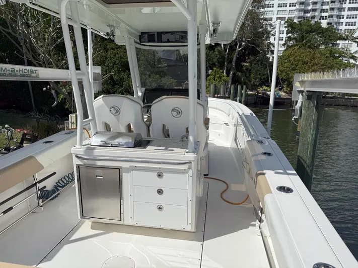 Dan's Seachelle Yacht Photos Pics Edgewater 320CC 2019 boat interior with seating and storage, docked near water.