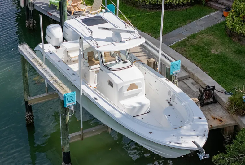 Dan's Seachelle Yacht Photos Pics 2019 Edgewater 320CC boat docked in a serene waterfront setting.
