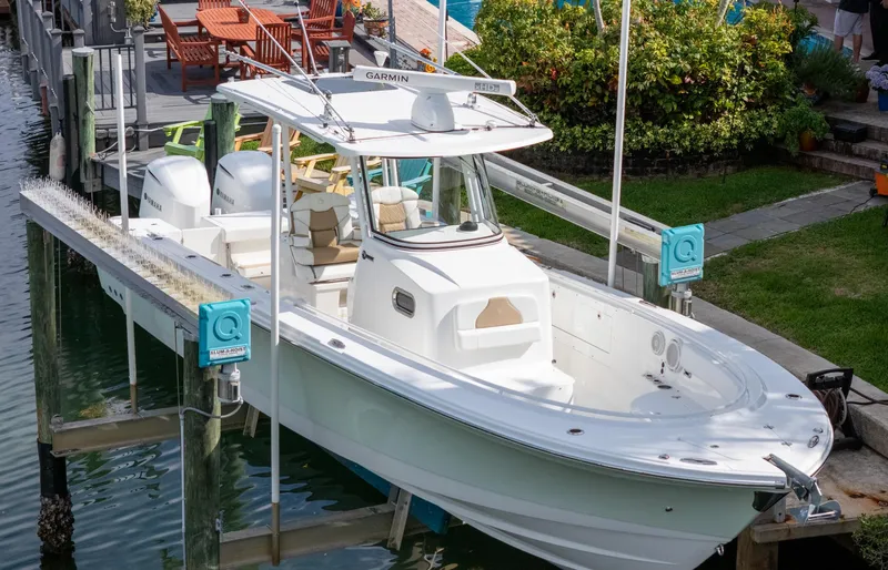 Dan's Seachelle Yacht Photos Pics 2019 Edgewater 320CC boat docked, featuring dual engines and spacious deck.