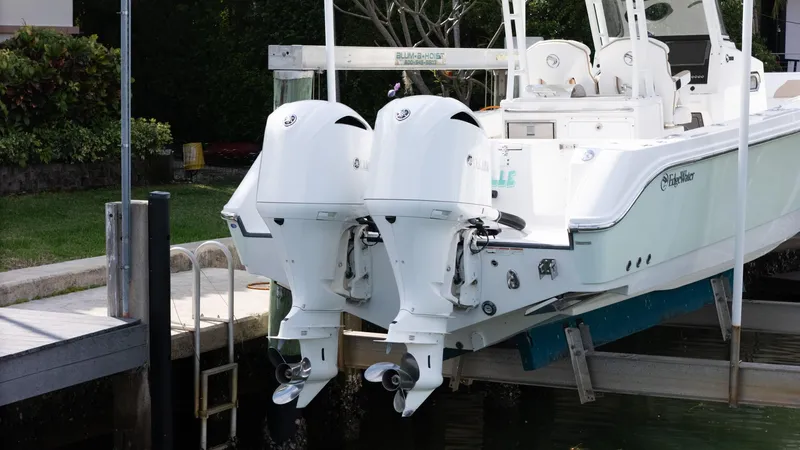 Dan's Seachelle Yacht Photos Pics Edgewater 320CC 2019 boat with dual outboard engines docked at marina.