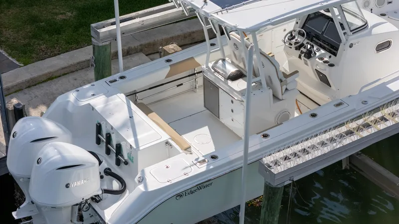 Dan's Seachelle Yacht Photos Pics 2019 Edgewater 320CC boat docked, featuring dual Yamaha engines and spacious cockpit.