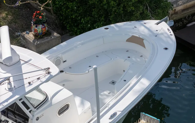 Dan's Seachelle Yacht Photos Pics 2019 Edgewater 320CC boat docked, featuring spacious white deck and sleek design.