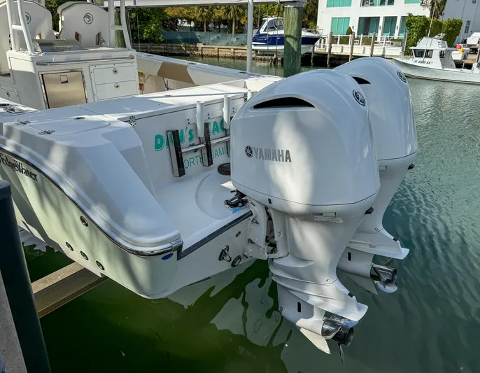 Dan's Seachelle Yacht Photos Pics 2019 Edgewater 320CC boat with twin Yamaha outboard engines docked in marina.