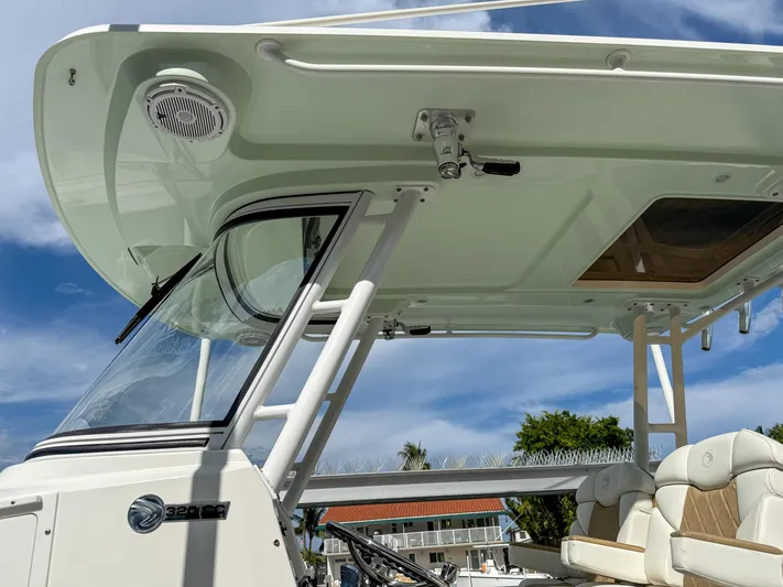 Dan's Seachelle Yacht Photos Pics 2019 Edgewater 320CC boat with sleek design and comfortable seating under a clear blue sky.