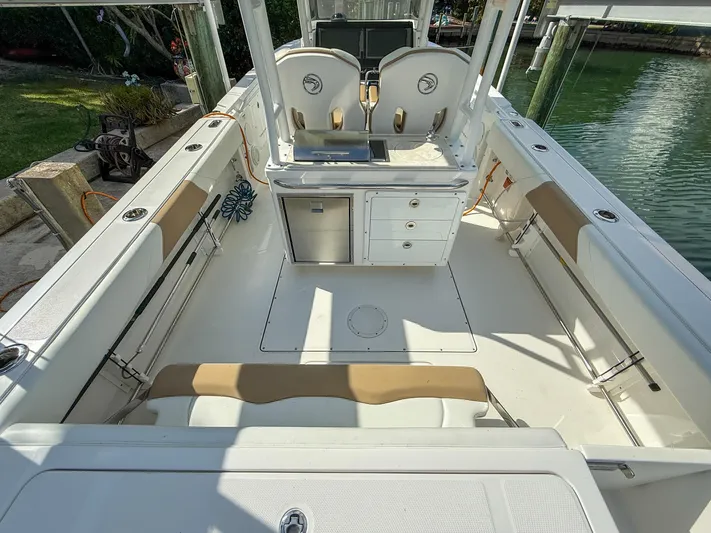 Dan's Seachelle Yacht Photos Pics 2019 Edgewater 320CC boat interior with seating, storage, and helm station.