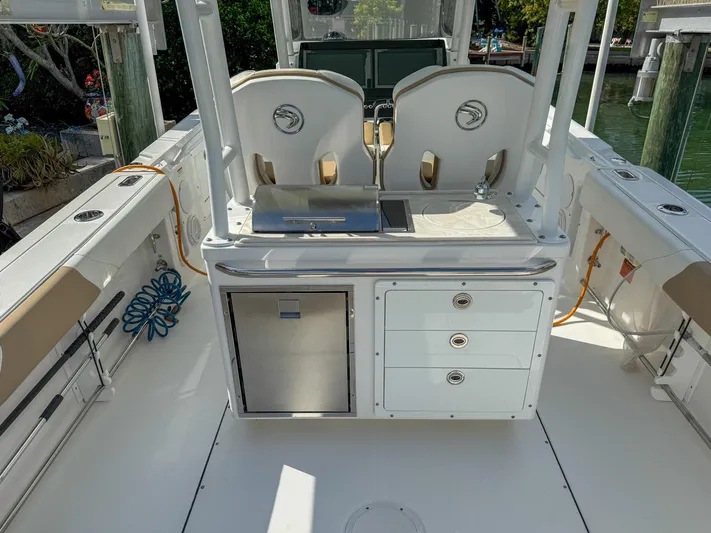 Dan's Seachelle Yacht Photos Pics 2019 Edgewater 320CC boat interior with seating and storage compartments.