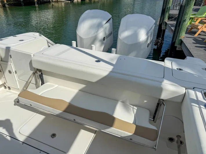 Dan's Seachelle Yacht Photos Pics 2019 Edgewater 320CC boat with foldable seating and dual Yamaha outboard engines.