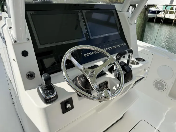 Dan's Seachelle Yacht Photos Pics 2019 Edgewater 320CC boat helm with dual screens and modern controls.