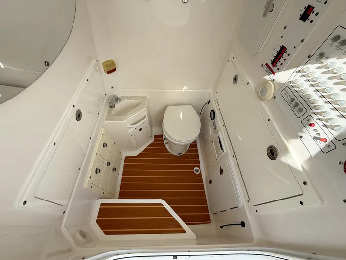 Dan's Seachelle Yacht Photos Pics 2019 Edgewater 320CC boat bathroom with wooden flooring and modern fixtures.