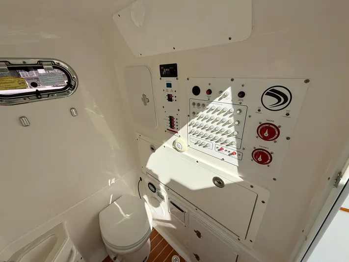Dan's Seachelle Yacht Photos Pics 2019 Edgewater 320CC boat interior with control panel and toilet.