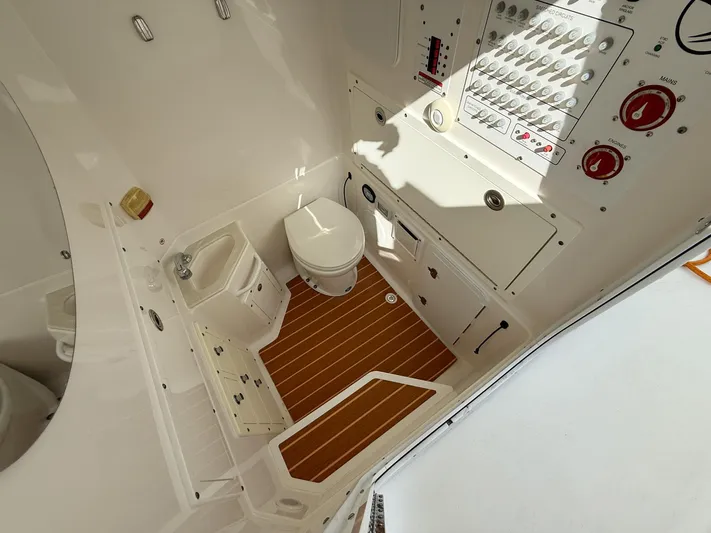 Dan's Seachelle Yacht Photos Pics 2019 Edgewater 320CC boat interior with toilet and control panel.