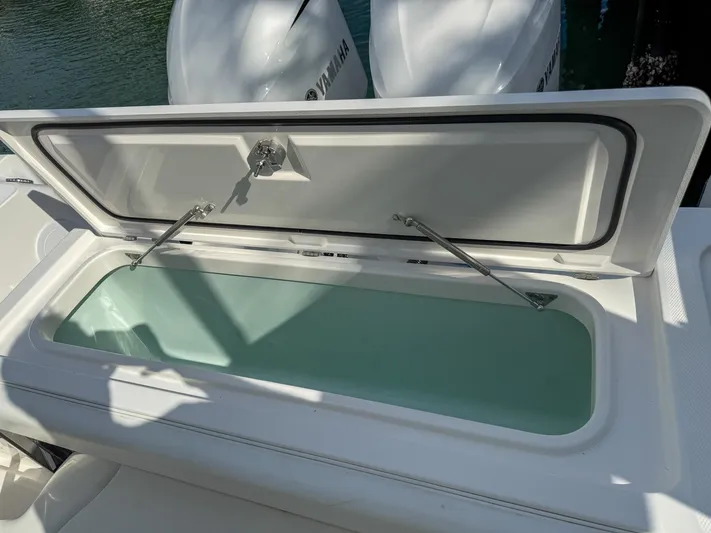 Dan's Seachelle Yacht Photos Pics Open storage compartment on 2019 Edgewater 320CC boat with Yamaha engines.