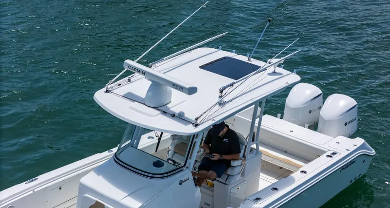 Dan's Seachelle Yacht Photos Pics 2019 Edgewater 320CC boat on water, featuring dual engines and a sleek design.