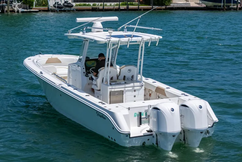 Dan's Seachelle Yacht Photos Pics 2019 Edgewater 320CC boat on water, featuring dual outboard engines.