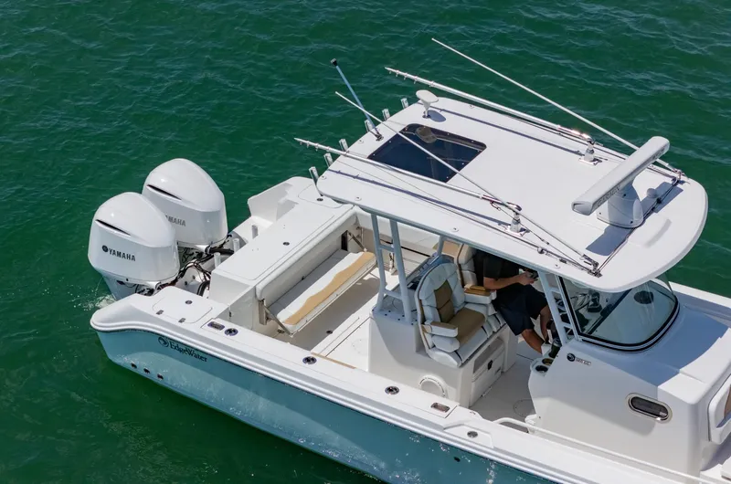 Dan's Seachelle Yacht Photos Pics 2019 Edgewater 320CC boat with dual Yamaha engines on clear water.
