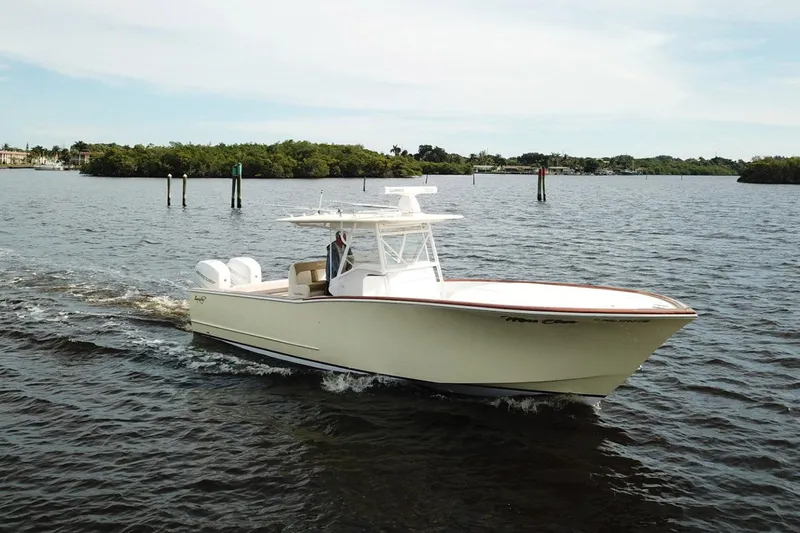 Dasher Yacht Photos Pics 2009 Bonadeo 34 Cuddy cruising on calm waters, showcasing sleek design and powerful engines.