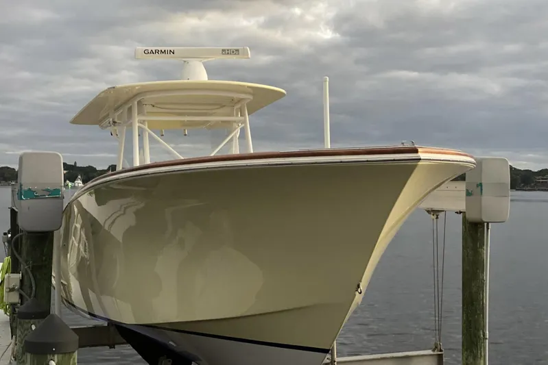 Dasher Yacht Photos Pics 2009 Bonadeo 34 Cuddy boat docked, featuring Garmin radar, under cloudy sky.