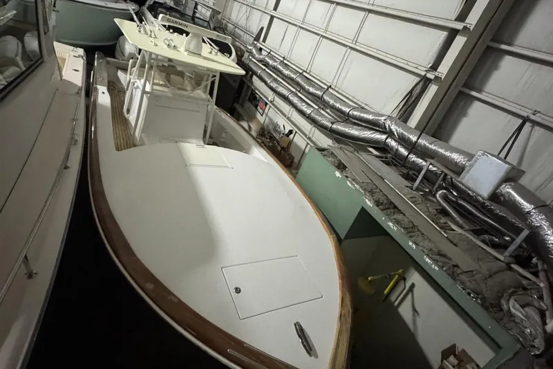 Dasher Yacht Photos Pics 2009 Bonadeo 34 Cuddy boat in storage, featuring a spacious deck and modern design.