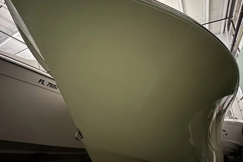 Dasher Yacht Photos Pics 2009 Bonadeo 34 Cuddy boat hull in storage, showcasing sleek design and craftsmanship.