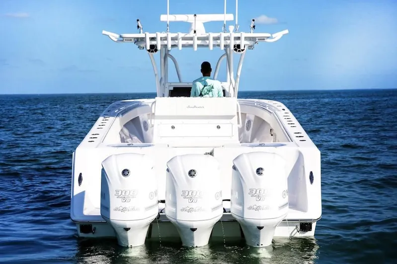 Yacht Photos Pics 2020 SeaHunter 33 Tournament boat with triple outboard engines on open water.