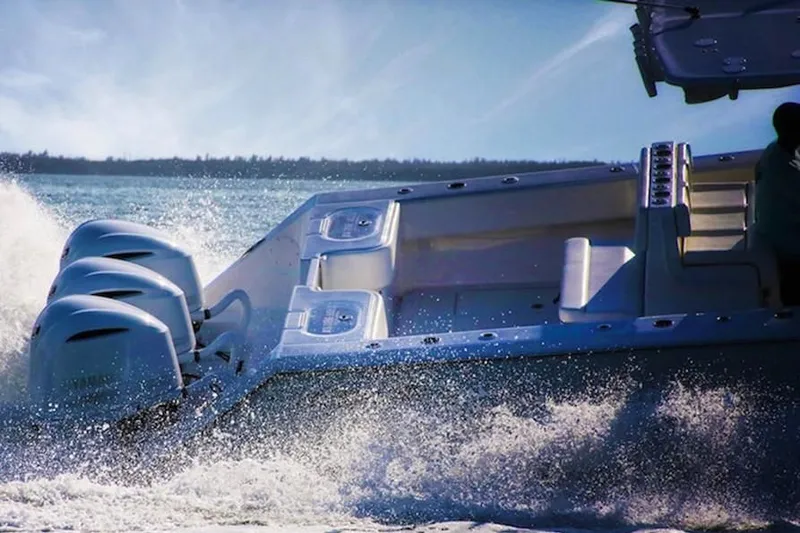  Yacht Photos Pics 2020 SeaHunter 33 Tournament boat cruising on open water with triple engines.