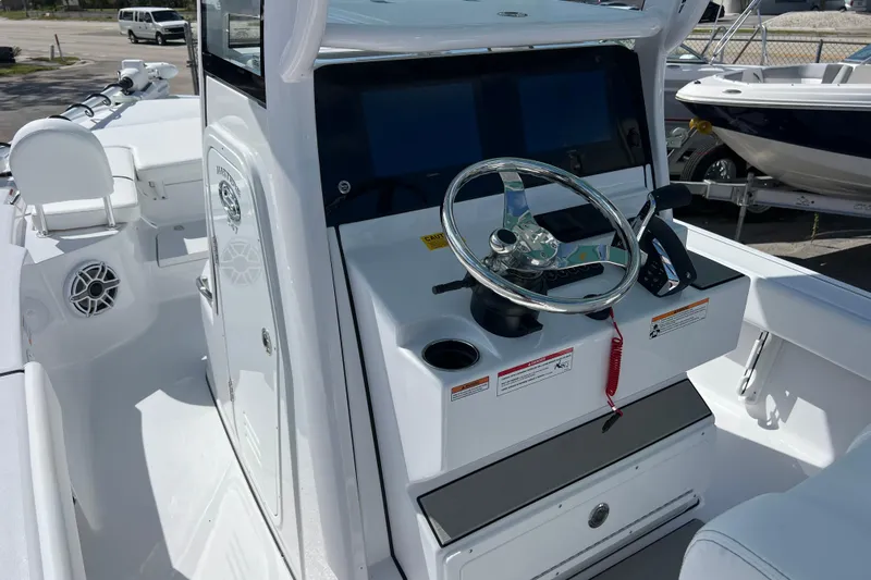  Yacht Photos Pics 2026 Sportsman Masters 247 Bay Boat cockpit with steering wheel and control panel.