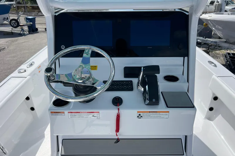  Yacht Photos Pics 2026 Sportsman Masters 247 Bay Boat helm with steering wheel and control panel.