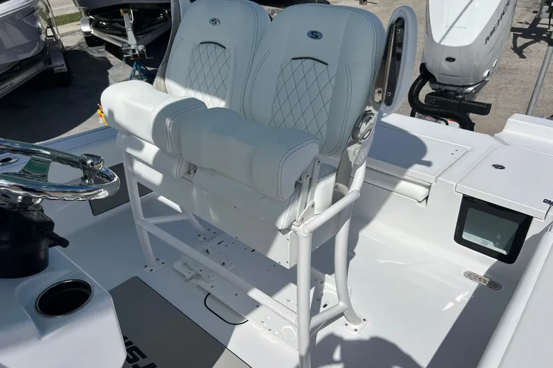  Yacht Photos Pics 2026 Sportsman Masters 247 Bay Boat helm with dual white seats and steering wheel.