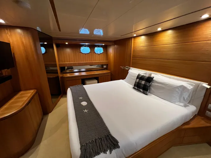 Koko Yacht Photos Pics Luxurious bedroom in a 2006 Sanlorenzo SL72 yacht with modern wooden interior.