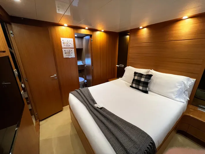 Koko Yacht Photos Pics Luxurious bedroom on a 2006 Sanlorenzo SL72 yacht with modern wooden interior.
