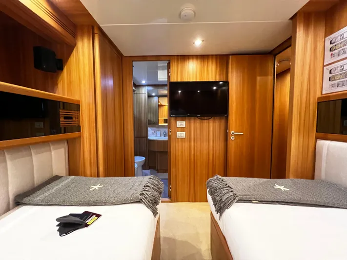 Koko Yacht Photos Pics Luxury cabin interior of 2006 Sanlorenzo SL72 yacht with twin beds and TV.