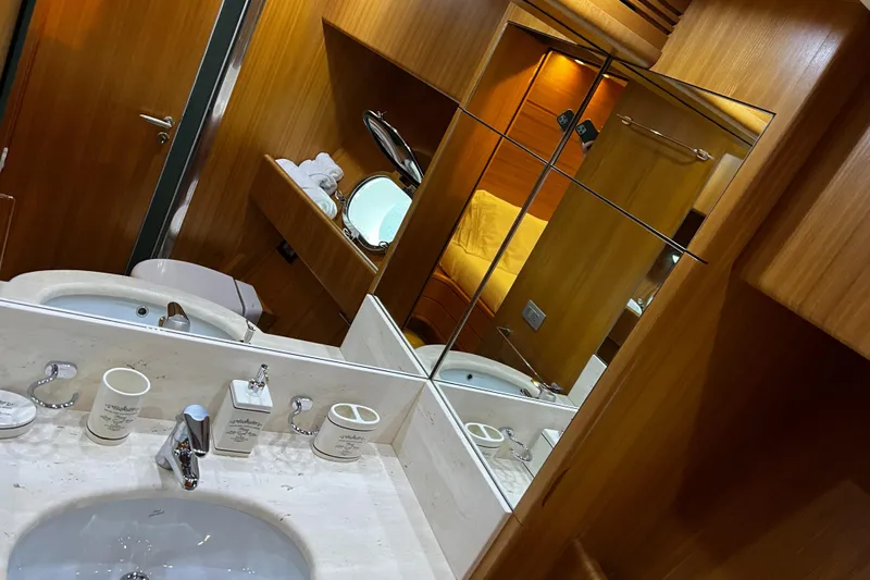 Koko Yacht Photos Pics Sanlorenzo SL72 2006 yacht bathroom with wooden cabinetry and marble sink.