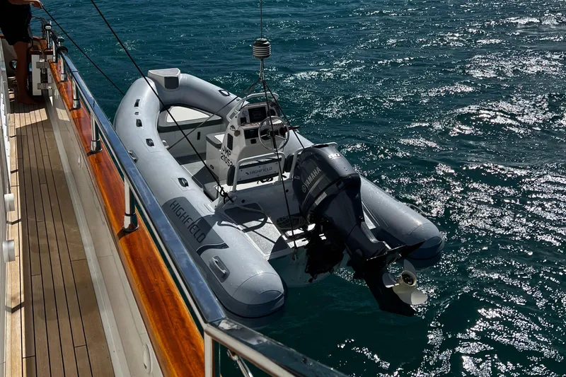 Koko Yacht Photos Pics Sanlorenzo SL72 2006 yacht with an inflatable tender boat on the water.