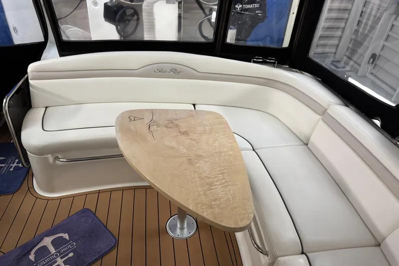  Yacht Photos Pics Luxurious interior of 2011 Sea Ray 370 Sundancer with elegant seating and wooden table.