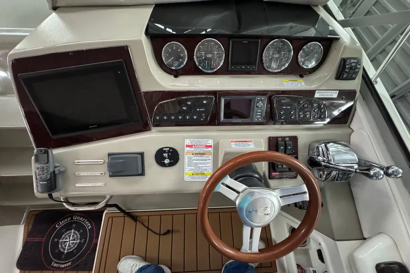  Yacht Photos Pics 2011 Sea Ray 370 Sundancer helm with gauges, controls, and wooden steering wheel.