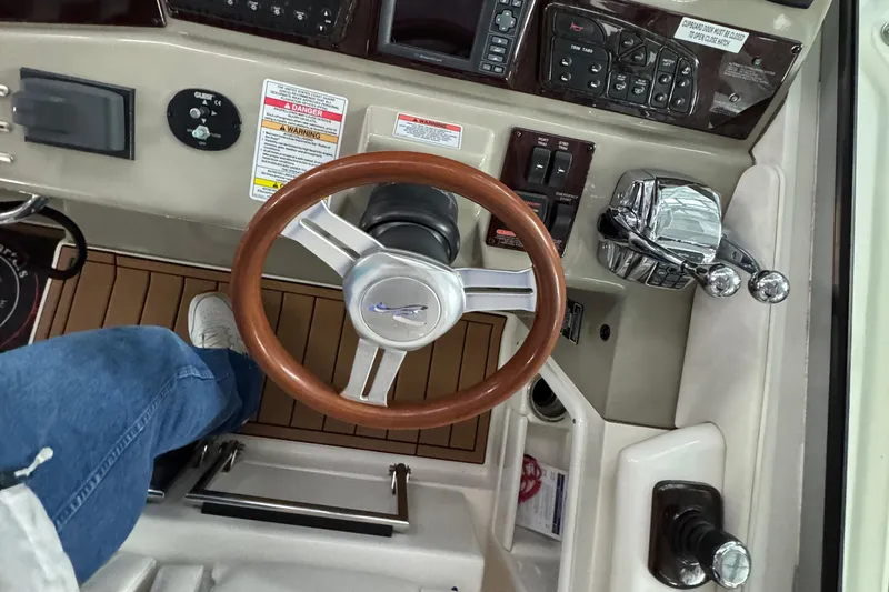  Yacht Photos Pics Helm of 2011 Sea Ray 370 Sundancer with wooden steering wheel and control panel.