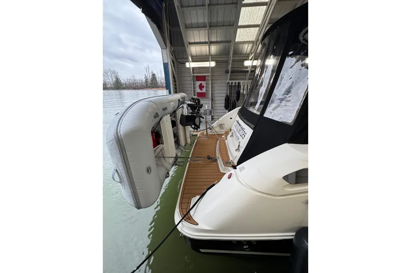  Yacht Photos Pics 2011 Sea Ray 370 Sundancer docked with inflatable boat, under covered marina.