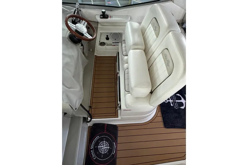  Yacht Photos Pics 2011 Sea Ray 370 Sundancer cockpit with white leather seats and wooden flooring.