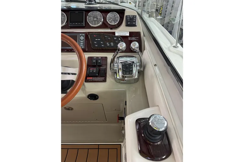  Yacht Photos Pics 2011 Sea Ray 370 Sundancer helm with steering wheel and control panel.