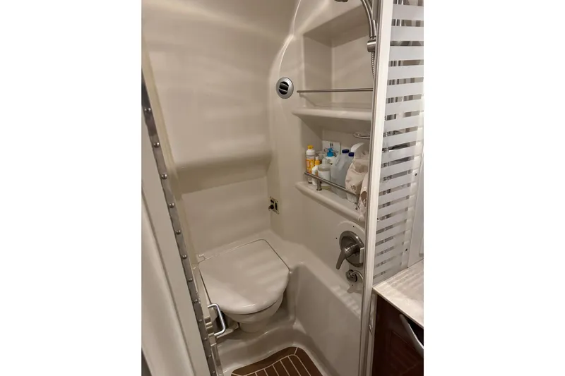  Yacht Photos Pics Bathroom interior of 2011 Sea Ray 370 Sundancer yacht, featuring shower and storage shelves.