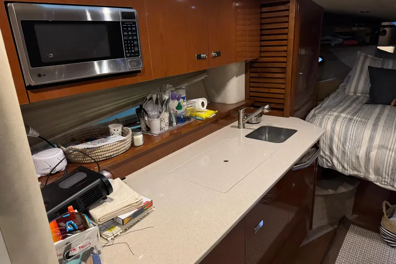  Yacht Photos Pics Interior of 2011 Sea Ray 370 Sundancer yacht with kitchenette and bed.