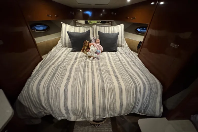  Yacht Photos Pics Luxurious cabin interior of 2011 Sea Ray 370 Sundancer with plush bedding and decorative pillows.