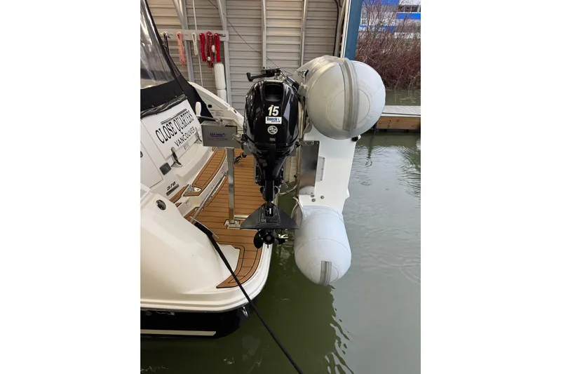  Yacht Photos Pics 2011 Sea Ray 370 Sundancer with outboard motor and inflatable dinghy in marina.