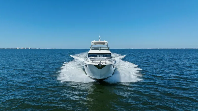 Radiant Yacht Photos Pics Prestige 630 Flybridge 2019 yacht cruising on open sea under clear blue sky.