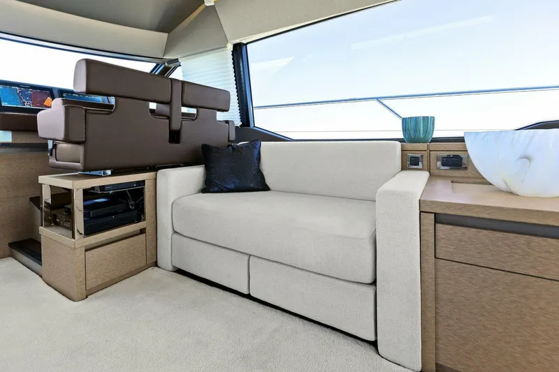 Radiant Yacht Photos Pics Luxurious interior of 2019 Prestige 630 Flybridge yacht with modern seating and decor.